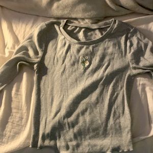 I’m selling a shrunken tee. It’s grey and has flowers in the middle.